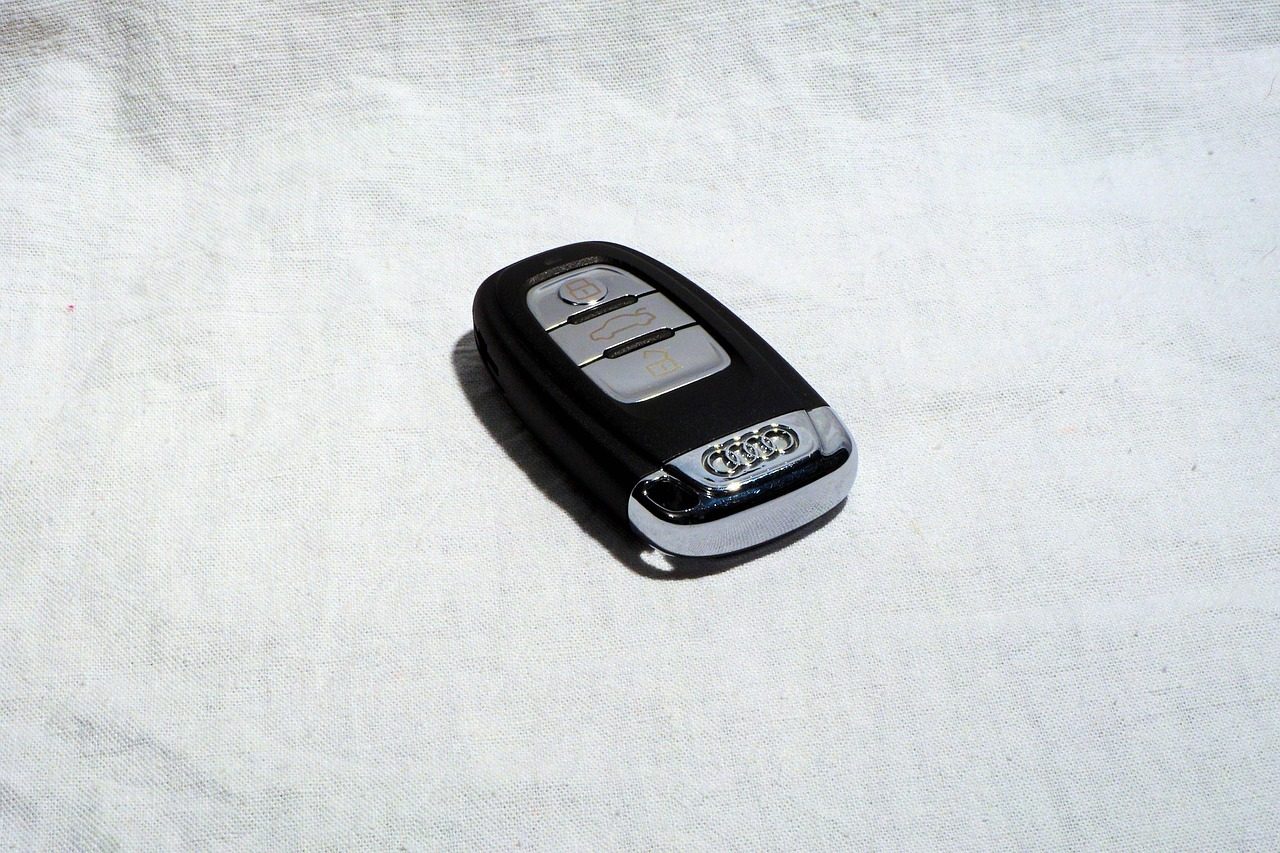 An Audi key fob lying on a piece of white fabric